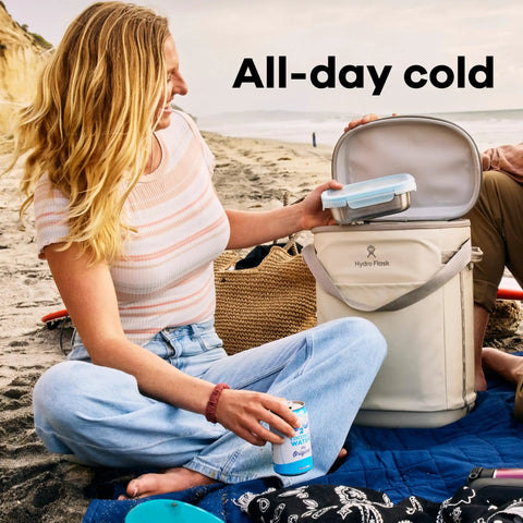 Carryout Cooler Backpack With All Day Cold Insulation And Portable Soft Build Trail And Park Friendly Features An Ergonomic Strap System 22 Liter Capacity In Shale Gray To Keep Your Stash Chill On The Go, beach setting, person using cooler.