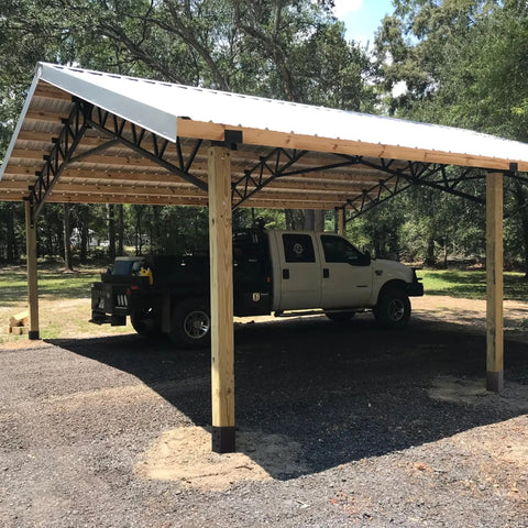 Open carport with wooden posts and steel roof using 4x4 Post Anchor Ground Spike Kit For Concrete Decks, Beefed-Up Steel With Black Powder Coat.