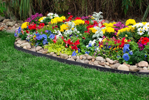 Tall Wall No Dig Landscape Edging Kit around colorful garden with rocks, flexible recycled plastic, quick install, all soil types.