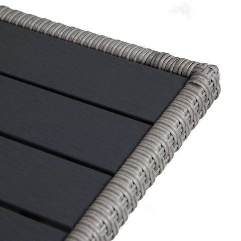 Corner detail of Outdoor Must Have Transitional Metal And All Weather Wicker Square Patio Table With Granite Base showing PE wicker edging.