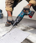 Worker using 5 In. By 11 In. SDS-Plus Bulldog Floor Scraper With Durable Steel Blade, Locking Bolt Attachment removing tiles