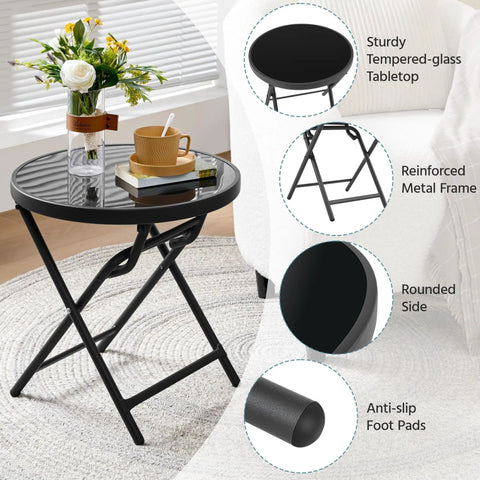 Outdoor Folding Round Patio End Table With Silk Tempered Glass Top And Lightweight Steel Frame next to a sofa in a living room.
