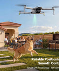 F11PRO 2 Drone With 6K Camera And 3 Axis Gimbal Stabilizer flying over a backyard, dog jumping, people seated outdoors.