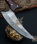 Beast Damascus Steel Skinner Knife with wood handle and leather sheath on rock