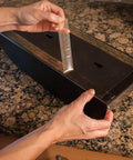 Applying Ultra Strong Clear Double Sided Mounting Tape 1 Inch Wide By 60 Inches Long Weatherproof Adhesive on a flat surface.