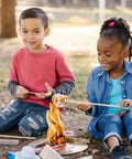 Children playing with Campfire S'mores Pretend Play Set With 23-Piece Toy Food Kit For Kids 3 Plus, including marshmallows and logs.
