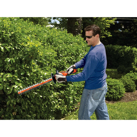 Man trimming hedge with 40V Max Cordless Hedge Trimmer With 24-Inch Dual-Action Blades Battery And Charger Included