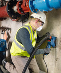 Worker in safety gear using diamond blade for cutting concrete, illustrating 14 Inch Standard Segmented Rim Diamond Blade With 1 Inch Arbor.