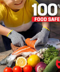 Child wearing Kids Cutting Gloves XS 8-12 Years preparing fish, showing food-grade safety and Level 5 cut protection.