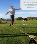 Man balancing on Backyard Slackline Kit Freestanding Slackline System For Kids And Adults in outdoor park setting