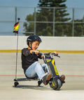 PowerRider 360 Drifting Trike Electric Ride On For Kids 9 MPH Top Speed With 40 Minute Run Time Dual Rear Caster Wheels For 360 Spins And Drifts Black Yellow, boy riding outdoors