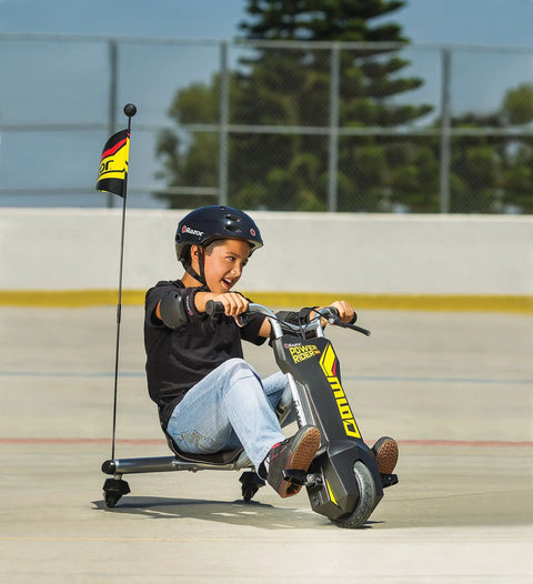 PowerRider 360 Drifting Trike Electric Ride On For Kids 9 MPH Top Speed With 40 Minute Run Time Dual Rear Caster Wheels For 360 Spins And Drifts Black Yellow, boy riding outdoors