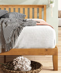 Top Tier Queen Platform Bed Frame With Tufted Fabric Headboard solid wood slats, heavy steel base, and stylish bedding.