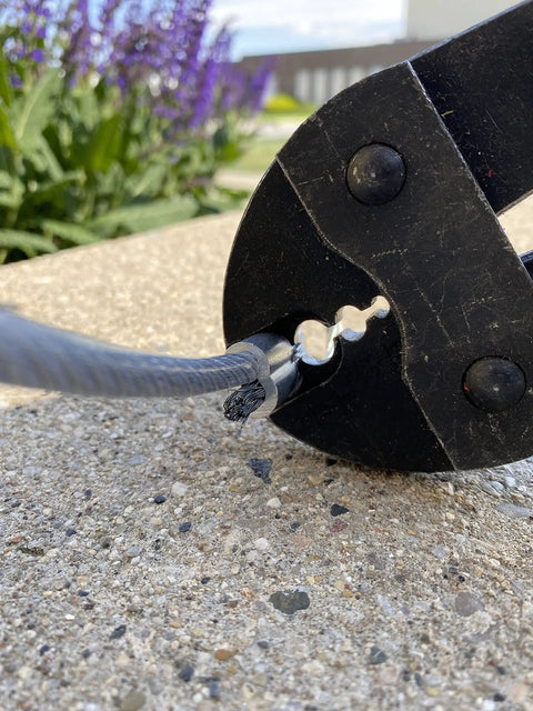 Close-up of 18 Inch Swaging Tool For Securing Ferrules And Stops On One Sixteenth Inch Three Thirty Second Inch One Eighth Inch And Three Sixteenth Inch Wire Rope And Cable Crimper With Steel Handle For Maximum Leverage And Solid Secure Crimps in use.