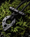 Fire Starter Necklace With Hex Ferro Rod Striker And Paracord Lanyard Up To Twelve Thousand Strikes on mossy ground