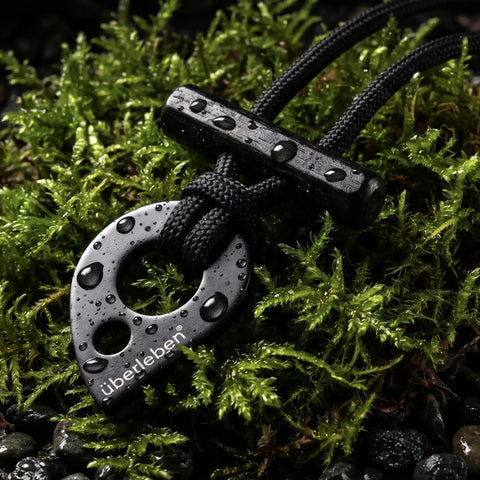 Fire Starter Necklace With Hex Ferro Rod Striker And Paracord Lanyard Up To Twelve Thousand Strikes on mossy ground