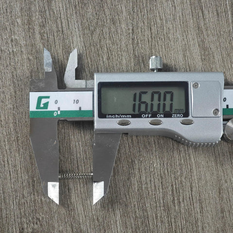 Stainless steel keyboard switch spring measured at 16.00 mm with digital caliper