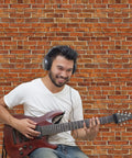 Man playing guitar in front of Brick Wallpaper Peel And Stick Set 4.5x9 Feet Removable Tablecloth Backdrop Self Adhesive