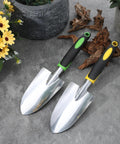 Two hand shovels from the 10 Piece Go To Garden Trowel Set With Heavy Duty Hand Shovels Soft TPR Handles on concrete surface.