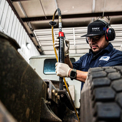 Mechanic uses Beast Heavy Duty Air Needle Scaler for tough surface prep on metal, showcasing use in industrial maintenance.