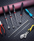 Six Piece Telescoping Magnetic Pickup Tool Set With Extendable Magnetic Sticks, Viewable Extendable Grabber on black grid surface.