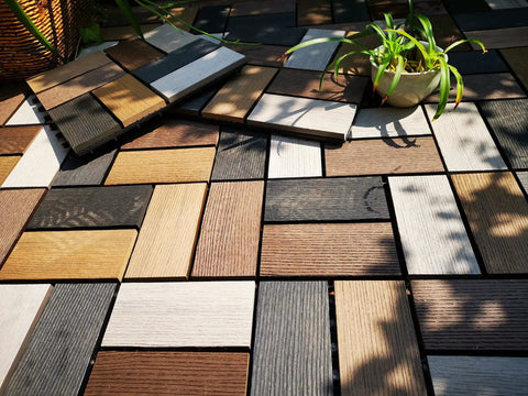 Durable Wood Plastic Composite Patio Deck Tiles With Interlocking Design For 3D Random Pattern DIY Floor Tiles outdoors in sunlight.