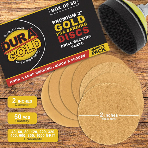 Pro Grade 2 Inch Hook And Loop Sanding Discs Variety Pack, displayed with backing plate on a wooden table.