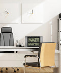 Office desk with Atomic Clock With Outdoor Temperature Sensor Wireless Indoor Outdoor Weather Station Real Time Temperature Readouts 330 Feet Transmission Range Auto DST Time Sync No Fuss Gray And Black placed on it.