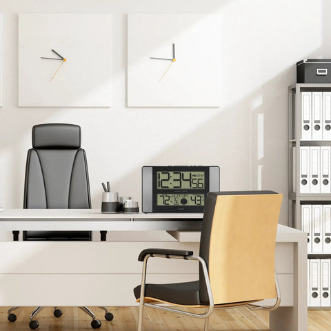 Office desk with Atomic Clock With Outdoor Temperature Sensor Wireless Indoor Outdoor Weather Station Real Time Temperature Readouts 330 Feet Transmission Range Auto DST Time Sync No Fuss Gray And Black placed on it.