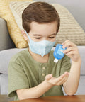 Child using sanitizer from Realistic Kids First Aid Kit For Pretend Doctor Play With 25 Accessories Including Gauze Pads And Bandages