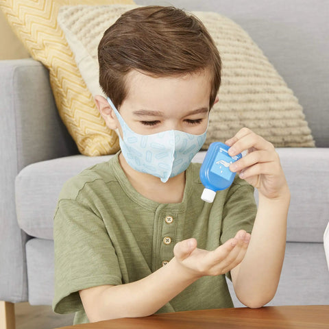 Child using sanitizer from Realistic Kids First Aid Kit For Pretend Doctor Play With 25 Accessories Including Gauze Pads And Bandages