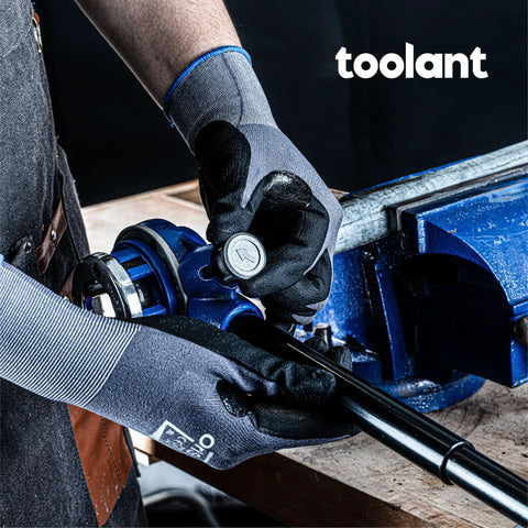 Person using All In One Ratcheting Pipe Threader Kit With 6 NPT Dies 1/4 Inch To 1-1/4 Inch on a pipe in a workshop setting.
