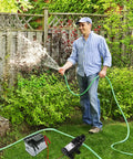Man using Heavy Duty 12 Volt Dc Diaphragm Water Pump With Hose Clamps For Rv Camper Marine And Utility Work straight shooter design in garden.