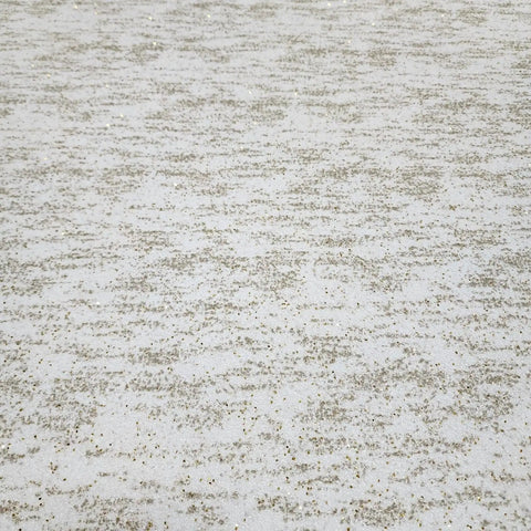 Close-up view of Top Shelf Vinyl Textured Wallpaper In Crisp Off White Cream Accented With Shimmery Gold Mica Chips.