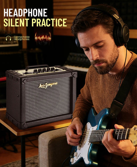 Musician using 20W Electric Guitar Amplifier With Carry Handle for practice with headphones, focus on amp's silent practice feature