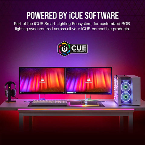 Desk setup with dual monitors, iCUE software branding, RGB lit PC case, keyboard, and headset, showcasing iCUE LS100 lighting.