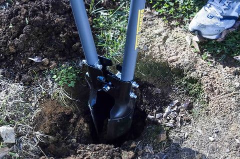 Post Hole Digger With 48 Inch Fiberglass Handle, Atlas Pattern Steel Point For Easy Holes in use, digging soil in a garden