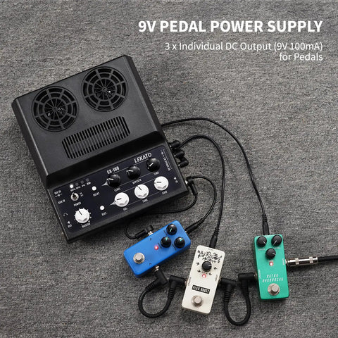 Portable 20W Rechargeable Guitar Amp With Distortion And Delay Effects next to pedal power supply and effects pedals on carpet