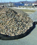 Sediment Filter Sock for Erosion Control and Storm Drain Protection, black sock, surrounds gravel pile, flexible design visible