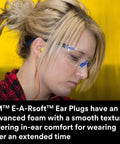 Person wearing protective glasses and corded E A Rsoft FX 312-1260 Disposable Foam Ear Plugs, NRR 33 for noise reduction.