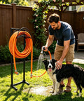 Heavy Duty Stainless Steel Garden Hose Reel With Triangle Reinforcement Brace Built Tough For Outdoor Use Supports Up To 150 Foot Hose Black Weather Resistant in use watering a dog in a backyard