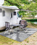Waterproof Outdoor Rug 5x8 Feet Double-Sided Palm Leaf Pattern Grey And White Plastic Patio Mat by an RV near a lake