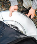 Person placing heat deflector into Medium Heat Deflector Carry Bag For Bonfire Accessories Weather Resistant Protective Gear Case