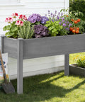 Waist-Height Raised Garden Bed With Legs, 48 By 24 By 30 Inch Solid Wood Planter Box Stand With Liner For Outdoor Patio, filled with plants.