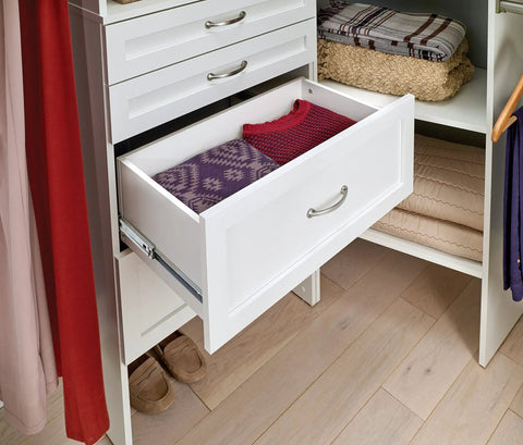 SuiteSymphony Wood Closet Drawer Add On Accessory For 25 Inch Wide Storage Tower Deep 10 Inch Tall Shaker Style Drawer Pure White Finish No Brainer Pick For Undergarments Socks Shirts And Small Garments open with folded clothes inside.