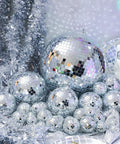 65 Piece Disco Ball Decor Set With Mixed Size Reflective Hanging Mirror Orbs for festive events displayed with garlands