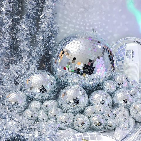65 Piece Disco Ball Decor Set With Mixed Size Reflective Hanging Mirror Orbs for festive events displayed with garlands