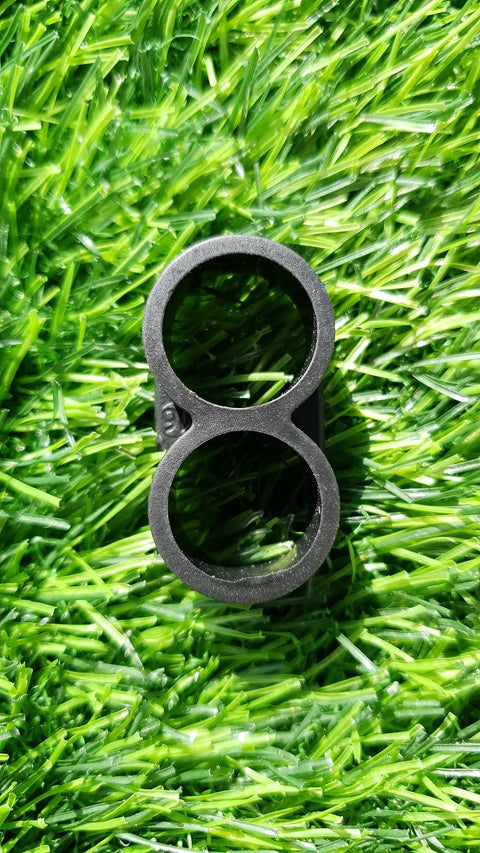 Drip Irrigation Fittings Kit For One Half Inch Tubing 0.600 ID, black plastic end cap connector on green grass background