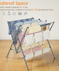 Heavy Duty Indoor Clothes Drying Rack With Twelve Solid Horizontal Rods And Tight Grip Sock Clips, holding clothes on a wooden floor.