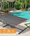 Cotton Double Hammock With 55 Inch Spreader Bar, Dark Gray, shown by a pool, Portable Camping Hammock Kit With Carrying Bag And Tree Straps